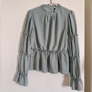 Sparkly, silver shirt with blue under cast